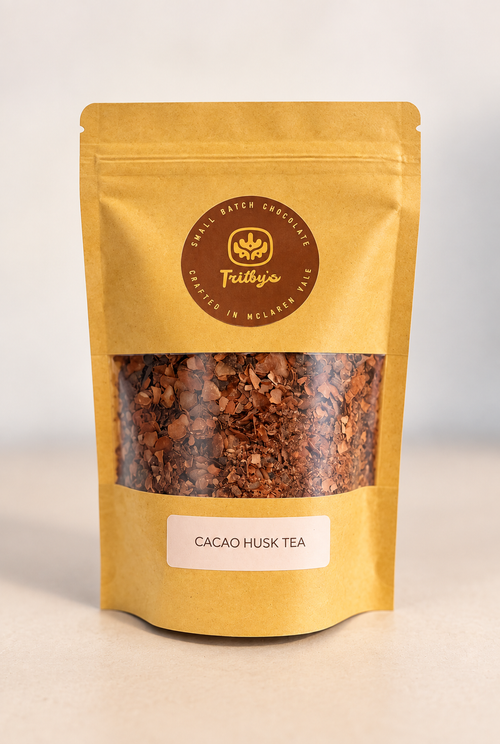 Cocoa Husk Chocolate Tea in a kraft pouch with a window showing the cacao husks