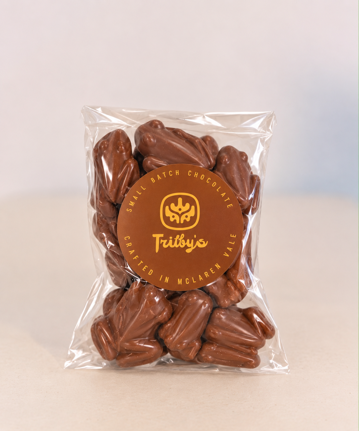 Milk chocolate frogs in a clear bag with a round Trilby's label