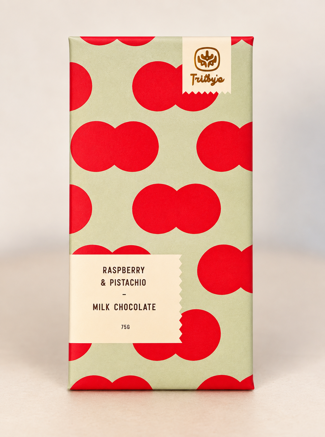 Raspberry & Pistachio milk chocolate bar in a pale green wrapper with red circles