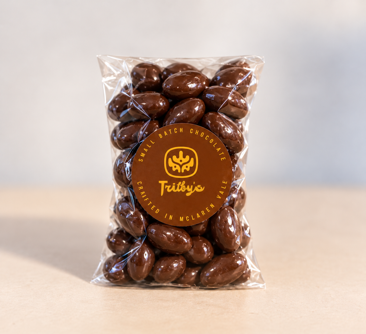 Dark chocolate coated almonds in a clear 200g bag with a round Trilby's label